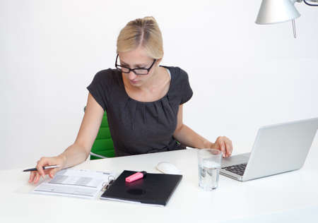 Young Business woman is smiling while working at work deskの写真素材