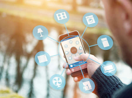 smart house, home automation, device illustration with app icons. It is in the nature holding his smartphone with smart home appの写真素材