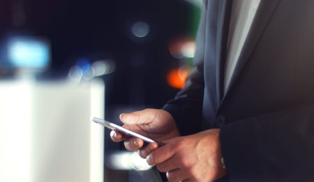 Business Man using mobile phone smart phone in the office. Typing, reading, scrolling the...