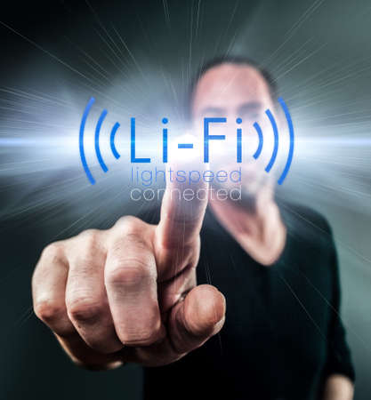 Li-Fi wireless technology, Internet and Networking concept - Young man Activates Li-Fi High speed connectionの写真素材