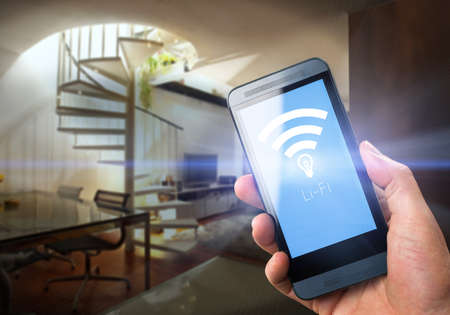 Li-Fi W-Lan technology, internet and networking concept - Young man activates Li-Fi High speed connectionの写真素材