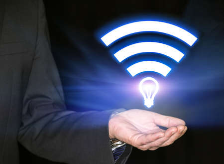 Li-Fi W-Lan technology, internet and networking concept - Young businessman activates Li-Fi High speed connectionの写真素材