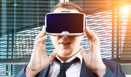 Businessman using his Virtual Reality VR glasses head mounted displayの写真素材
