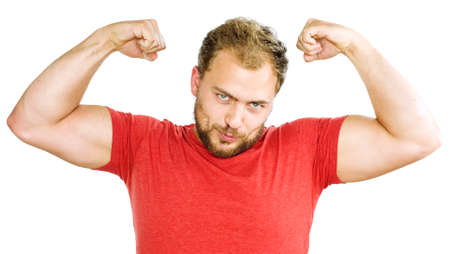 Young man showing his muscles and smiles, success of daily training.の写真素材