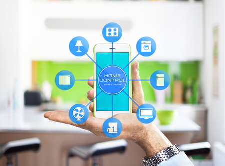 Using smart home app on phone. Smart home, remote control concept.の写真素材