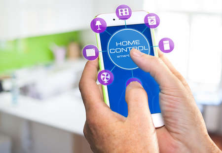 Using smart home app on phone. Smart home, remote control concept.の写真素材