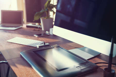 Computer on desktop in hipster workplace officeの写真素材