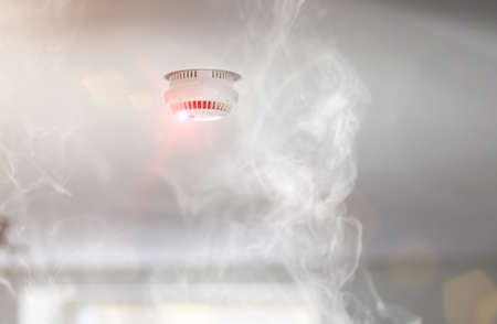 Smoke detector mounted on roof in apartment