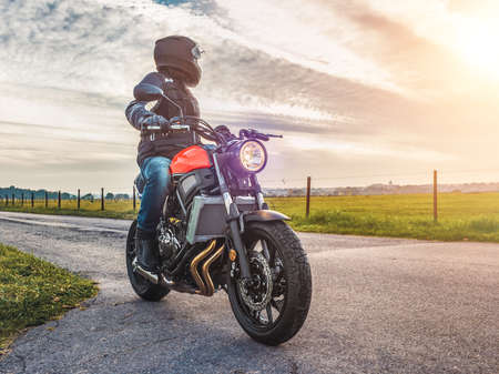 motorbike on the road riding. having fun driving the empty road on a motorcycle tour journey. copyspace for your individual text.の写真素材