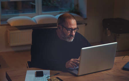 Mature businessman calculating finance. Horizontal shotの写真素材
