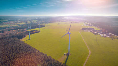 Wind turbines and agricultural fields on a summer day - Energy Production with clean and Renewable Energy - aerial shotの写真素材