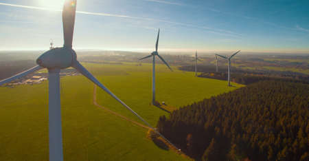 Wind turbines and agricultural fields on a summer day - Energy Production with clean and Renewable Energy - aerial shotの写真素材