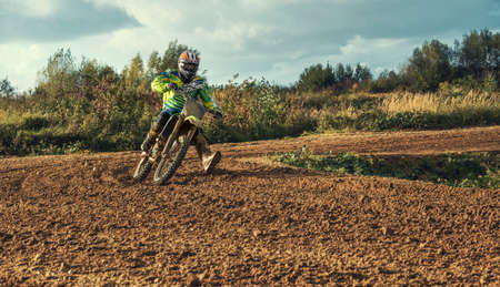Arnoldsweiler, Germany, October 05,2017: Extreme Motocross MX Rider riding on dirt track on a sunny late summer day on public training session in preparation for motocross event.のeditorial素材
