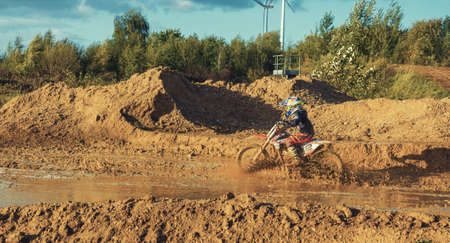 Arnoldsweiler, Germany, October 05,2017: Extreme Motocross MX Rider riding on dirt track on a sunny late summer day on public training session in preparation for motocross event.のeditorial素材