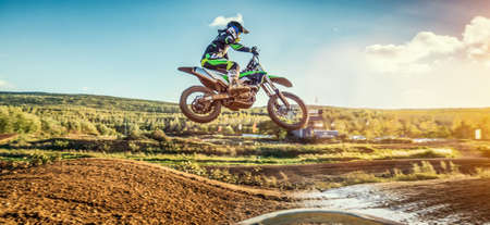 Extreme Motocross MX Rider riding on dirt track on a sunny late summer day on public training session in preparation for Motocross eventの写真素材