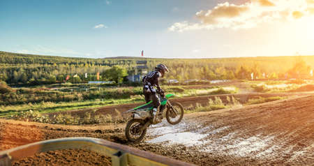 Extreme Motocross MX Rider riding on dirt track on a sunny late summer day on public training session in preparation for Motocross eventの写真素材