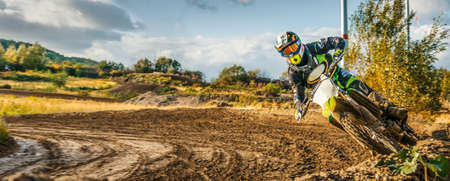 Extreme Motocross MX Rider riding on dirt track on a sunny late summer day on public training session in preparation for Motocross eventの写真素材