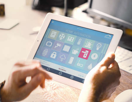 smart house device smartphone with app icons on tablet pcの写真素材