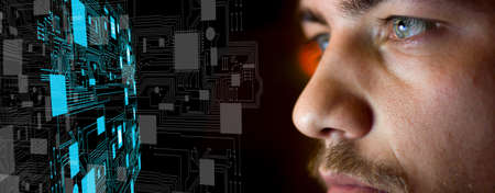 Young man in front of motherboard architecture - future technology conceptの写真素材