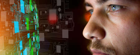 Young man in front of motherboard architecture - future technology conceptの写真素材