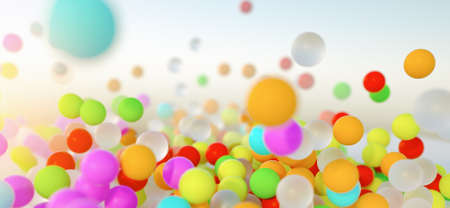 colorful bouncing balls outdoors against blue sunny skyの写真素材