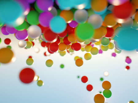 colorful bouncing balls outdoors against blue sunny skyの写真素材