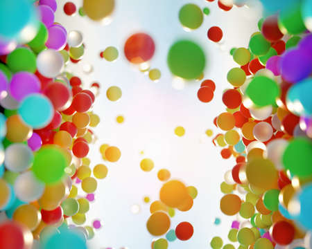 colorful bouncing balls outdoors against blue sunny skyの写真素材