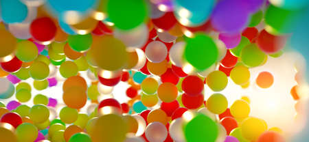 colorful bouncing balls outdoors against blue sunny skyの写真素材