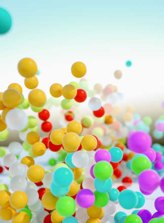 colorful bouncing balls outdoors against blue sunny skyの写真素材