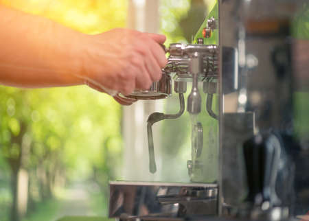 Espresso pouring from classic coffee machine into small white cup. Close-up Shot.の写真素材