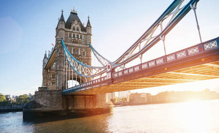 The London Tower bridge at sunrise on a sunny summer day - shot against blue clear sky into the shining sunの写真素材