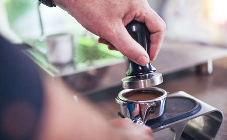 Coffee flour just pressed into filter holder for fresh espresso coffeeの写真素材