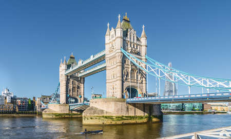 The London Tower bridge at sunrise on a sunny summer day - shot against blue clear sky into the shining sunの写真素材