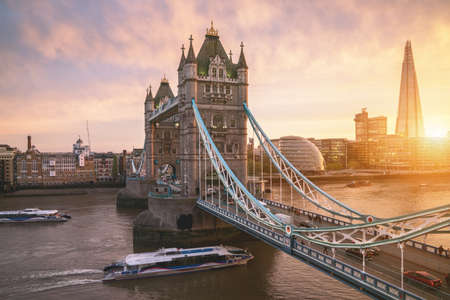 The London Tower bridge at sunrise on a sunny summer day - shot against blue clear sky into the shining sunの写真素材