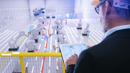 Smart automation industry robot in action welding metall while engineer uses his remote control table pc- industry 4.0 concept - 3D renderingの写真素材