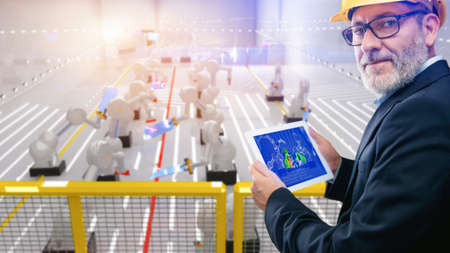 Smart automation industry robot in action welding solar panels while engineer is watching from above - industry 4.0 concept - 3D Renderingの写真素材