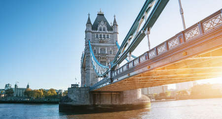 The London Tower bridge at sunrise on a sunny summer day - shot against blue clear sky into the shining sunの写真素材