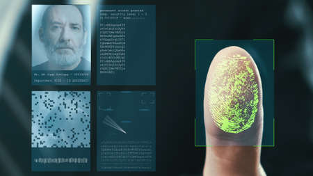 Futuristic digital processing of fingerprints as man holds his hand against a modern fingerprint scanner. Futuristic digital technology and transparent citizen concept.の写真素材