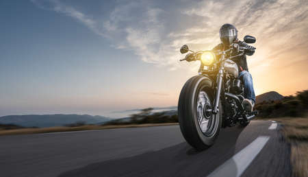 motorbike on the road riding. having fun driving the empty highway on a motorcycle tour journey. copyspace for your individual text.の写真素材