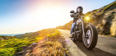 motorbike on the coast road riding. having fun driving the empty highway on a motorcycle tour...