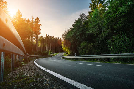 Long Curvy Forest Road In Alpine Mountainsの写真素材
