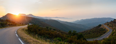 Mediterranean sea coast road into mountains horizon in summer with beautiful bright sun rays - wide angle panorama shotの写真素材