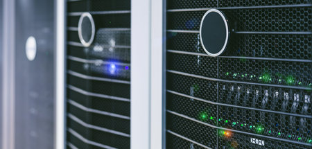 Server units in cloud service data center showing flickering light indicators for massive data...