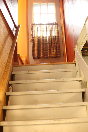 Interior basement staircase view from bottom step.の写真素材