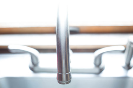 Kitchen sink faucet with window view.の写真素材