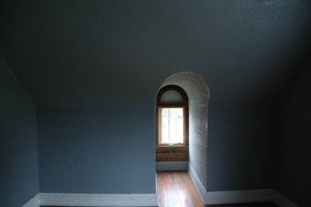 Keyhole window in an empty roomの写真素材