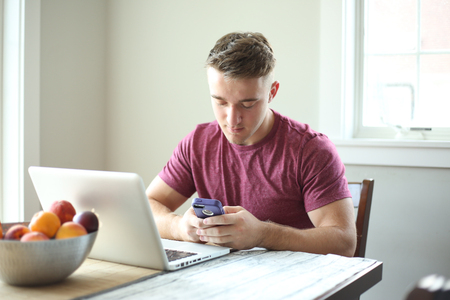 Portrait of a young handsome man using technology.の写真素材