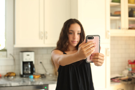 Young girl with cellphone - selfie.の写真素材