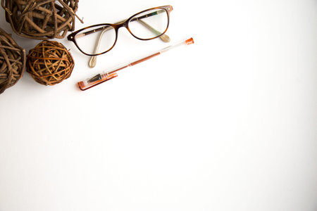 Balls, glasses and pen on white background shot overhead.