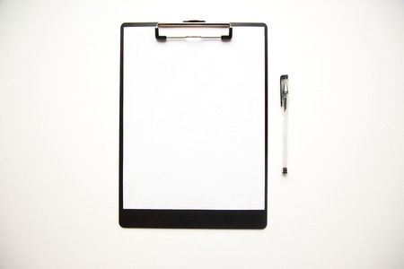 Clipboard and pens on white background shot overhead.の写真素材